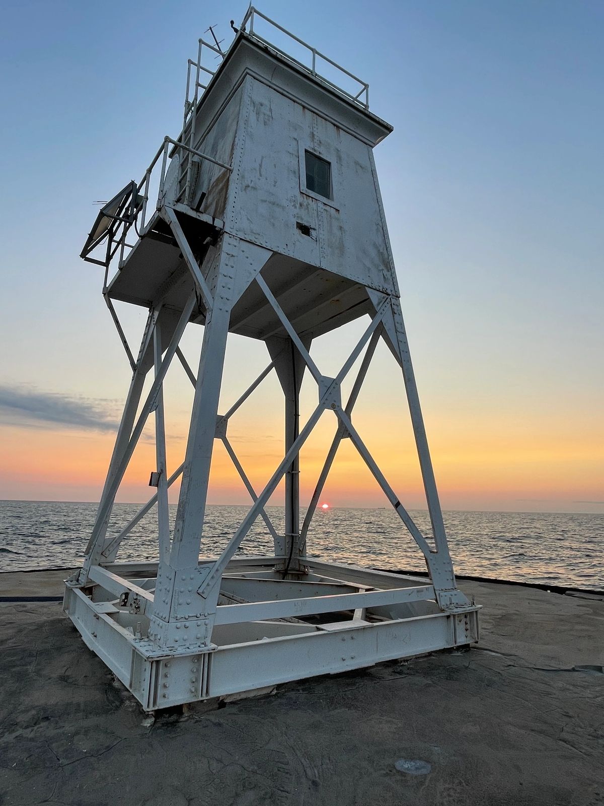 The Grand Marais harbor light tower at sunset over Lake Superior